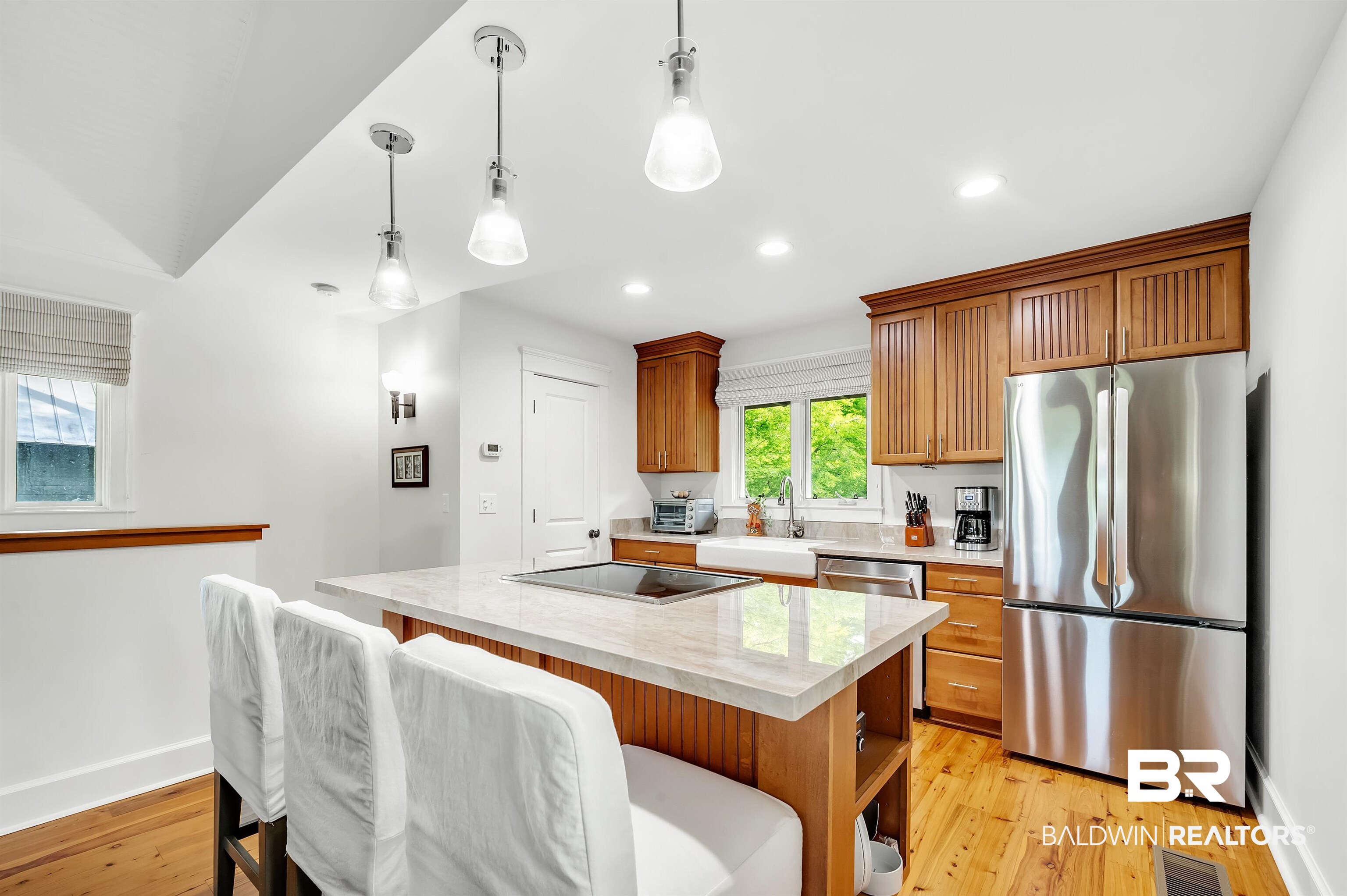 32760 Steelwood Ridge Road, Unit 7 Loxley, AL 36551 - Photo 22 of 64 Kitchen with appliances with stainless steel finishes, a sink, a kitchen island, light wood-style floors, and hanging light fixtures