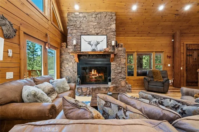 a living room with furniture a chandelier and a flat screen tv