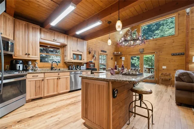 a kitchen with stainless steel appliances granite countertop a stove and cabinets