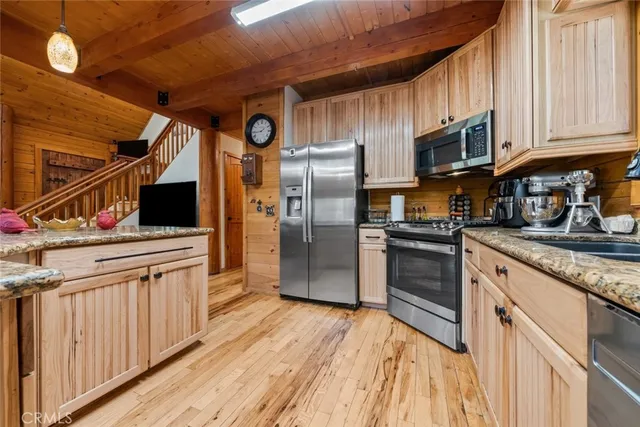 a bed sitting in a spacious bedroom next to a window