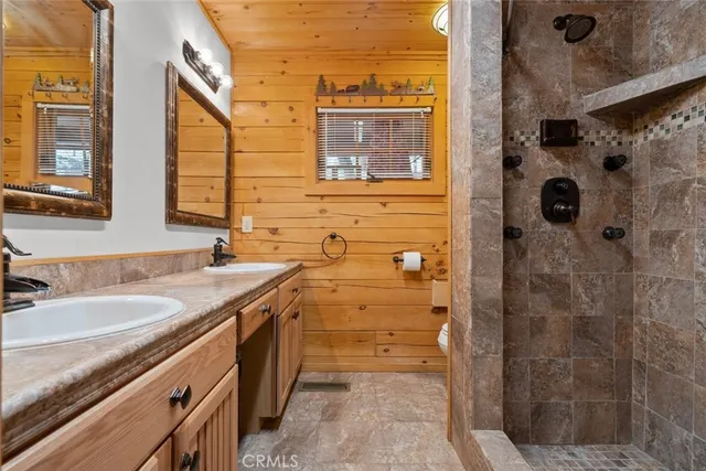 a bathroom with a granite countertop bunch a sink and a mirror