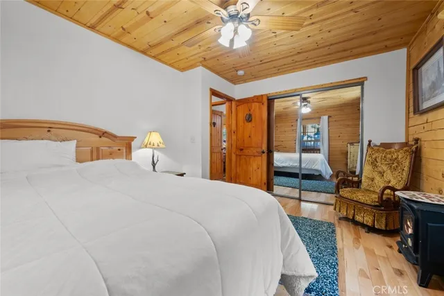 a bedroom with double bed and a large window