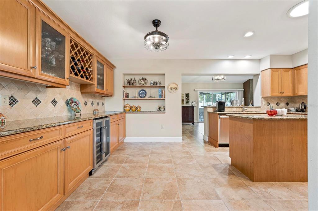 104 Alba Street West Venice, FL 34285 - Photo 12 of 42 a large kitchen with stainless steel appliances granite countertop a stove refrigerator and cabinets