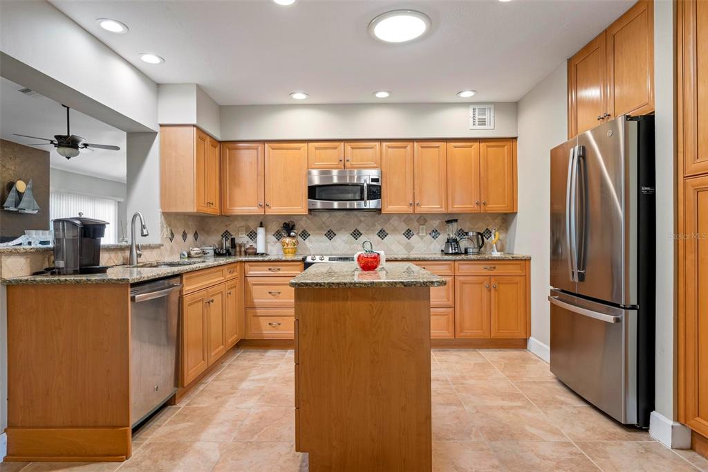 104 Alba Street West Venice, FL 34285 - Photo 14 of 42 a kitchen with refrigerator and cabinets