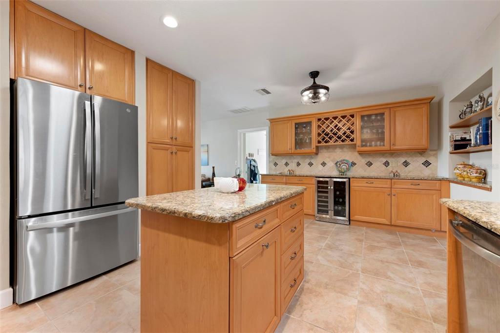 104 Alba Street West Venice, FL 34285 - Photo 16 of 42 a kitchen with stainless steel appliances granite countertop a refrigerator a sink a stove and white cabinets