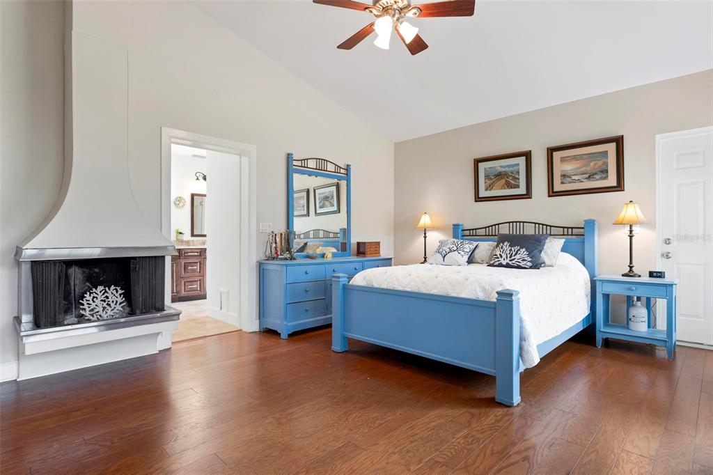 104 Alba Street West Venice, FL 34285 - Photo 22 of 42 a bedroom with a bed and a fireplace