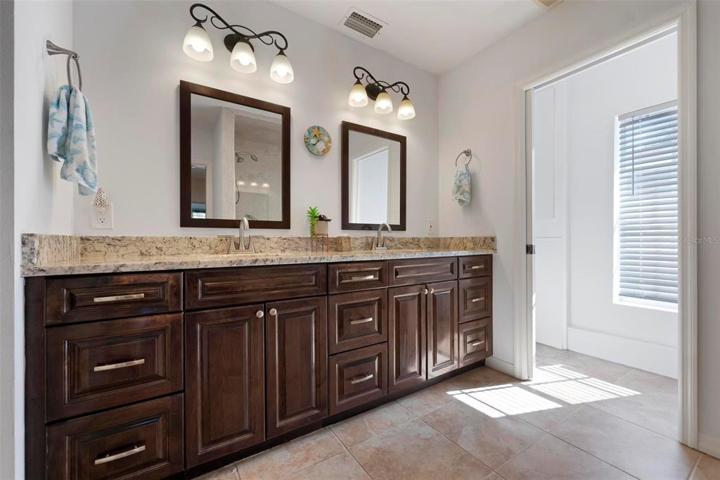 104 Alba Street West Venice, FL 34285 - Photo 25 of 42 a bathroom with a granite countertop double vanity sink and a mirror