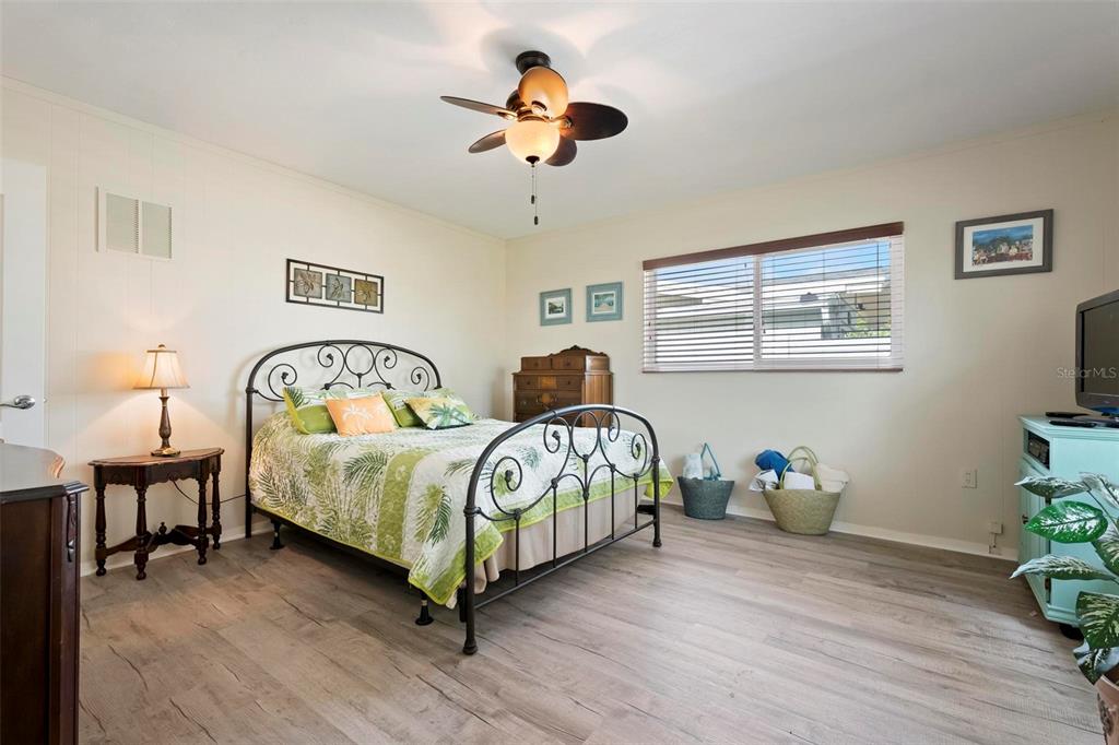 104 Alba Street West Venice, FL 34285 - Photo 28 of 42 a bedroom with bed and a chandelier