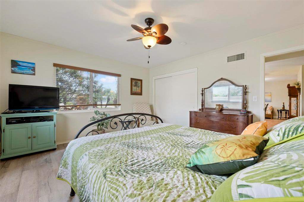 104 Alba Street West Venice, FL 34285 - Photo 29 of 42 a bedroom with a bed and a chandelier