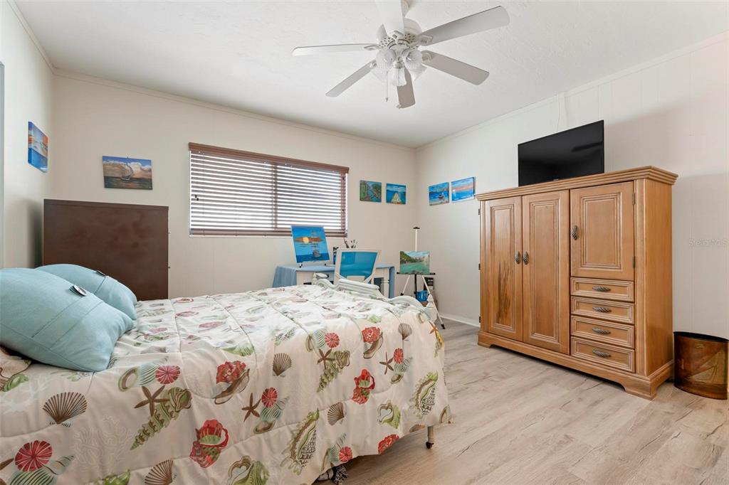 104 Alba Street West Venice, FL 34285 - Photo 31 of 42 a bedroom with a bed and a flat screen tv
