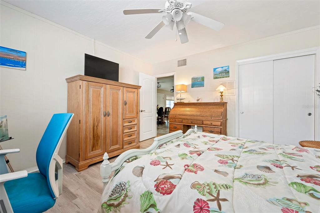 104 Alba Street West Venice, FL 34285 - Photo 32 of 42 a bedroom with a bed and a flat screen tv