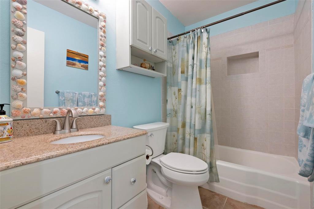 104 Alba Street West Venice, FL 34285 - Photo 33 of 42 a bathroom with a granite countertop sink toilet and shower