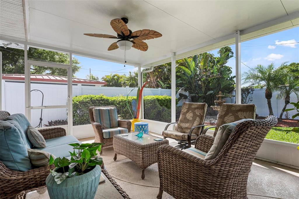 104 Alba Street West Venice, FL 34285 - Photo 37 of 42 a living room with patio furniture and a floor to ceiling window