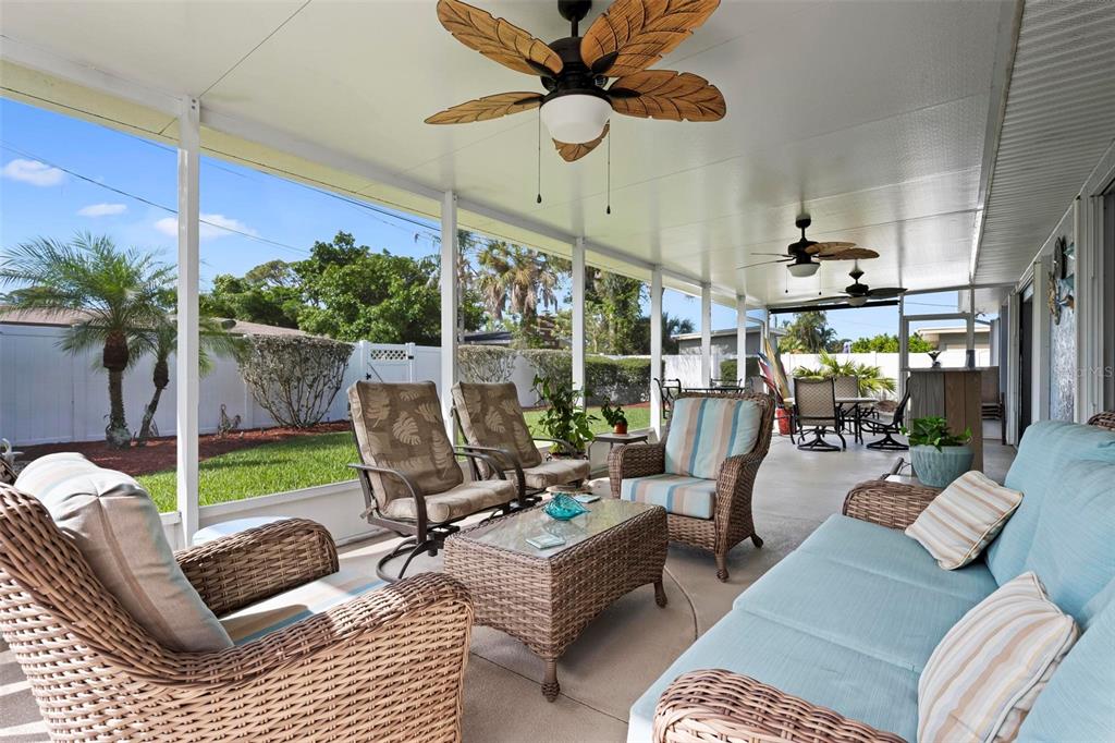 104 Alba Street West Venice, FL 34285 - Photo 38 of 42 a living room with patio furniture and a floor to ceiling window