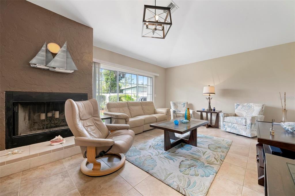 104 Alba Street West Venice, FL 34285 - Photo 4 of 42 a living room with furniture and a fireplace