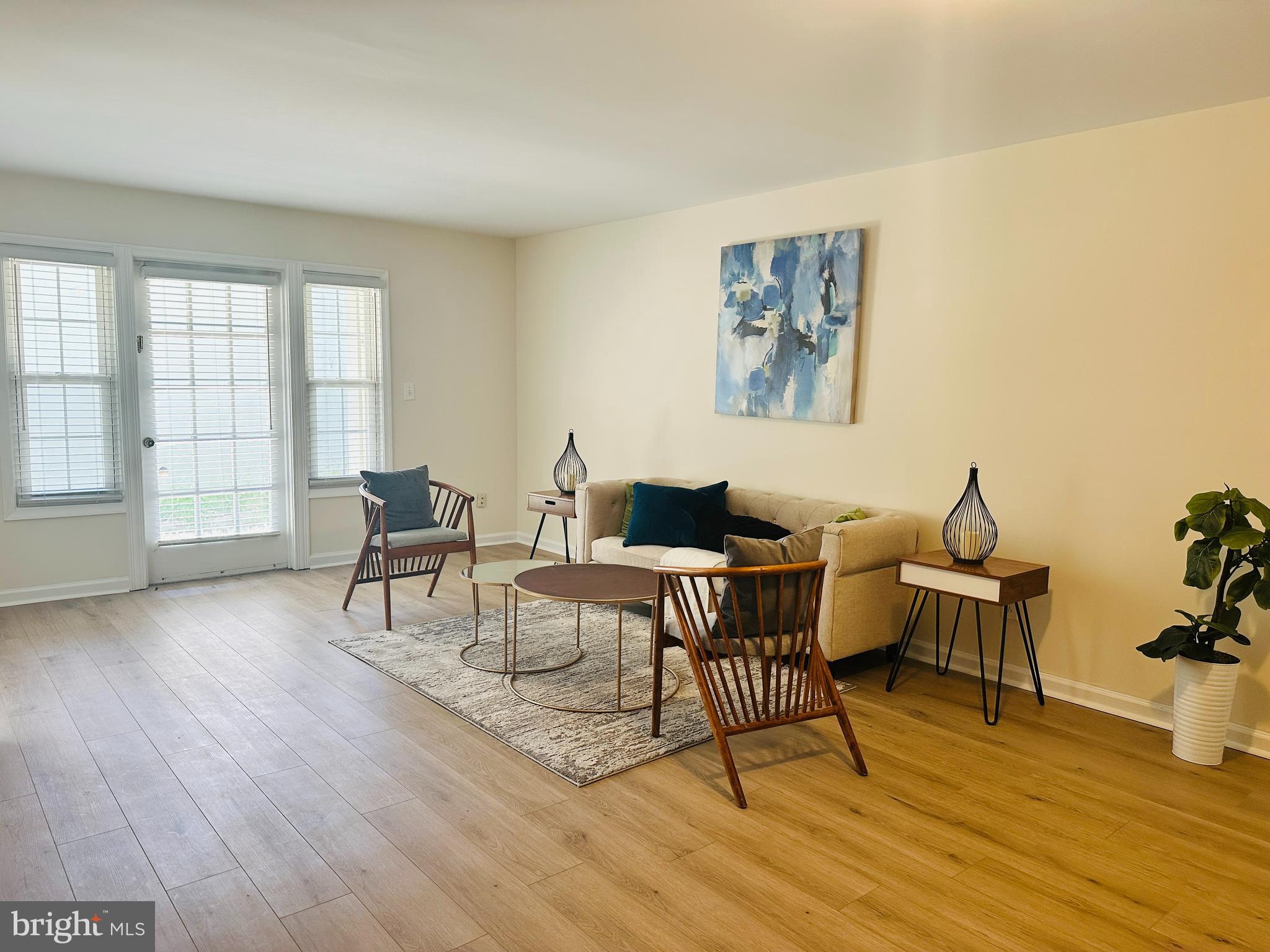 8312 Kingsgate Road, Unit 534 Springfield, VA 22152 - Photo 11 of 32 a living room with furniture and a wooden floor