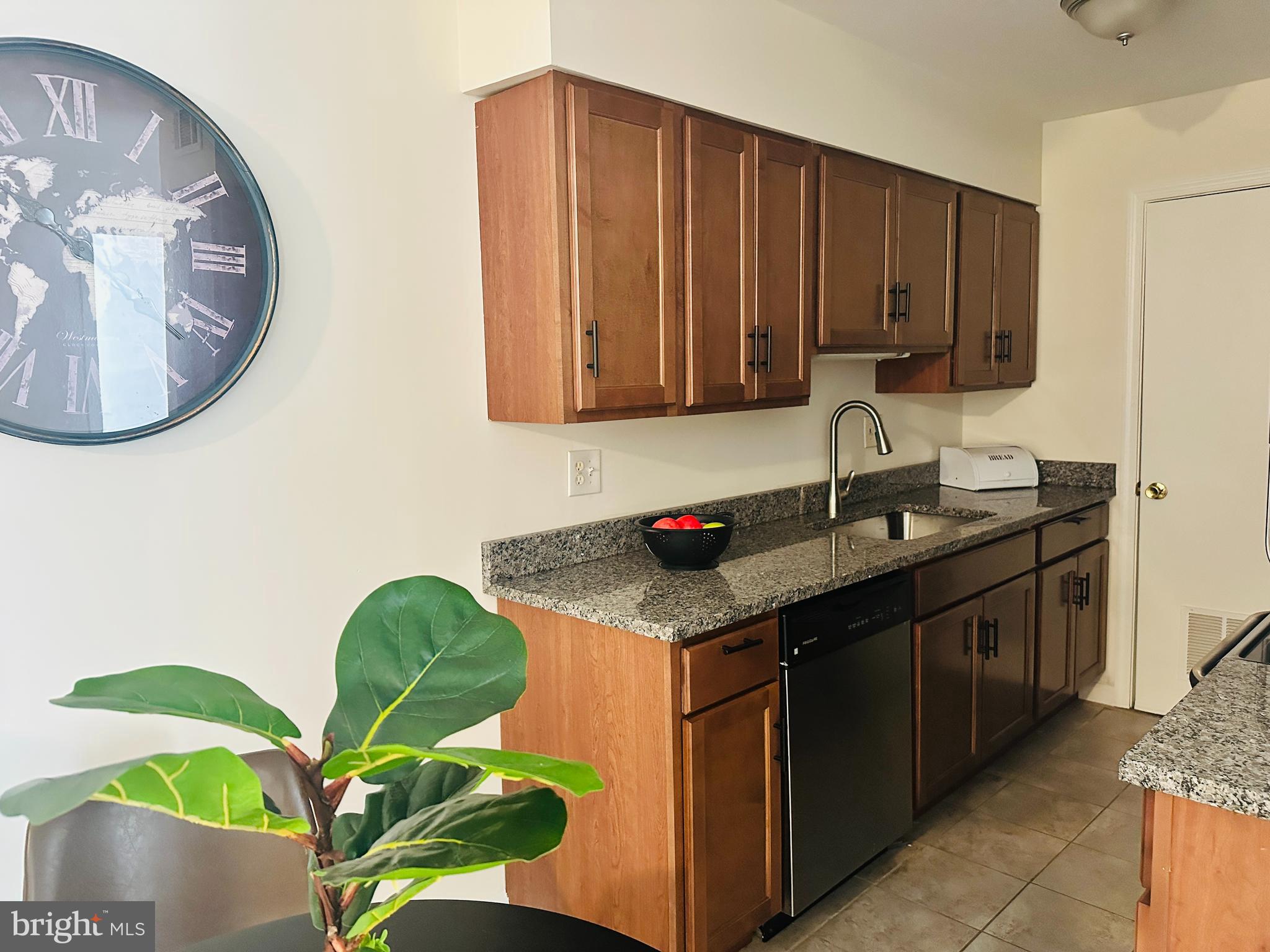8312 Kingsgate Road, Unit 534 Springfield, VA 22152 - Photo 13 of 32 a kitchen with a sink a stove and cabinets