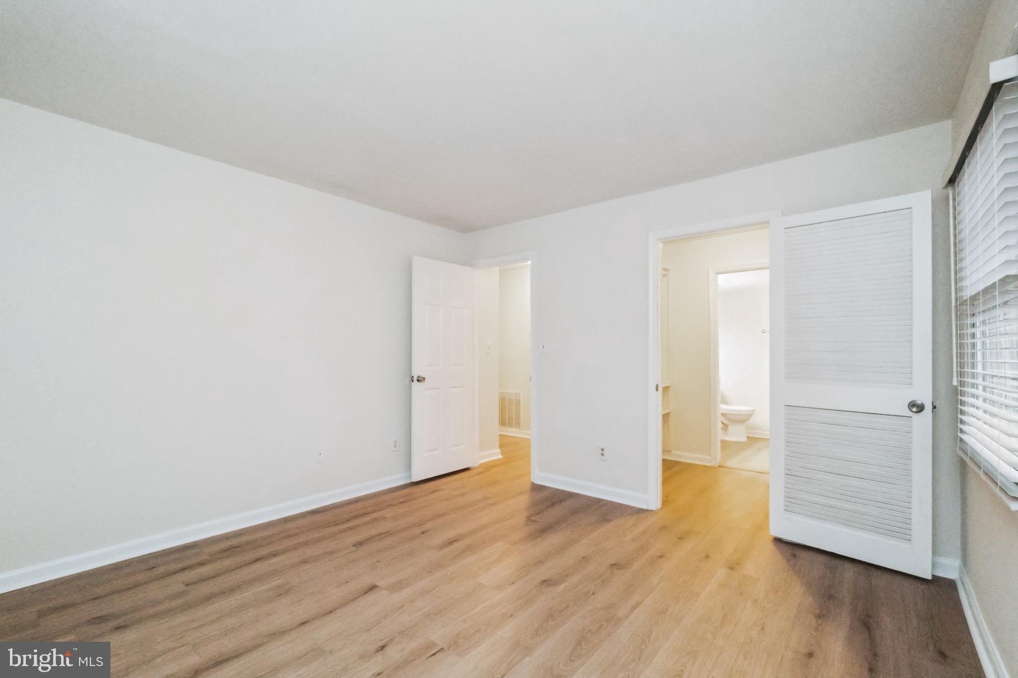 8312 Kingsgate Road, Unit 534 Springfield, VA 22152 - Photo 19 of 32 a view of an empty room with wooden floor and closet
