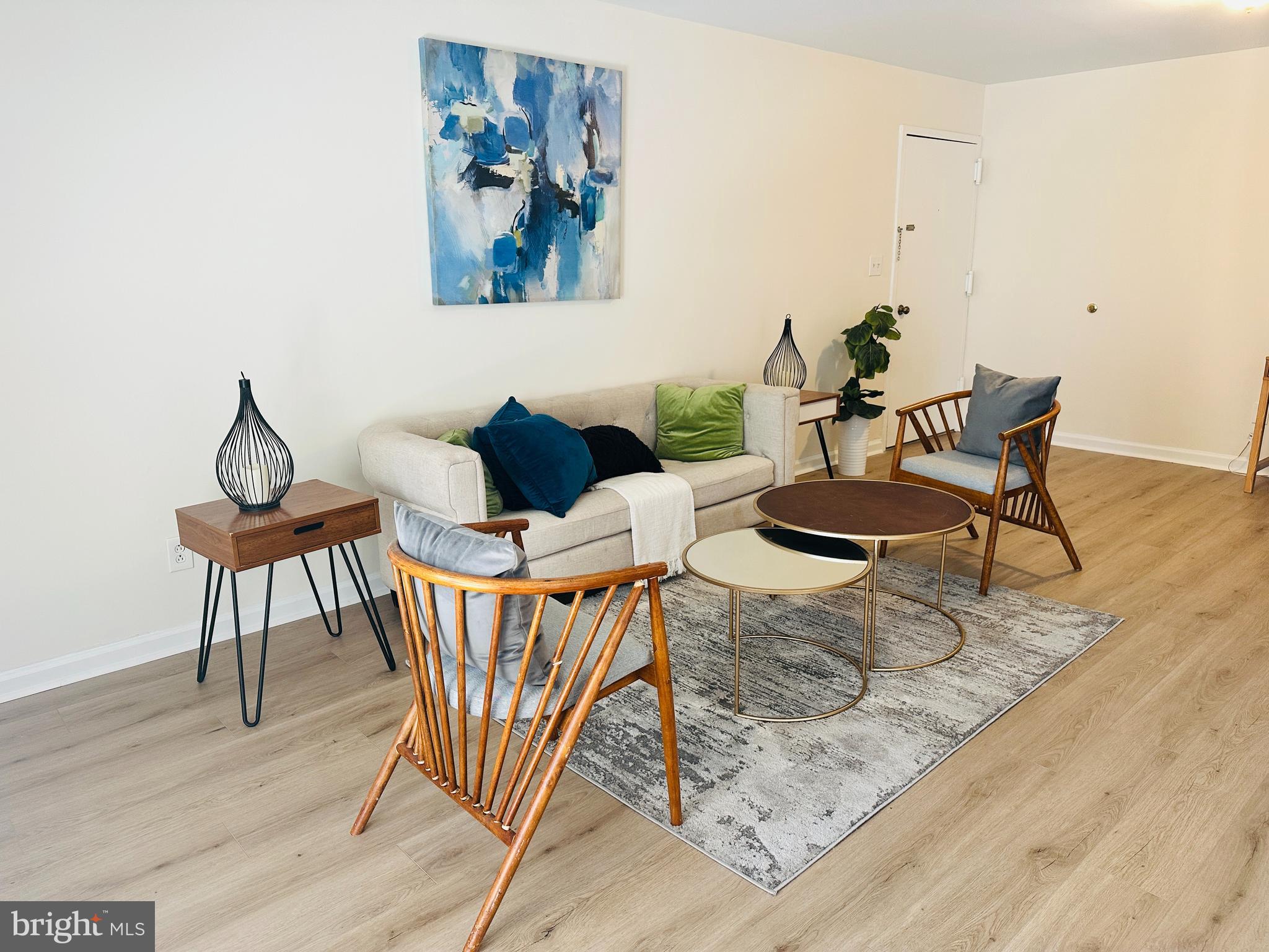 8312 Kingsgate Road, Unit 534 Springfield, VA 22152 - Photo 7 of 32 a view of a dining room with furniture and wooden floor