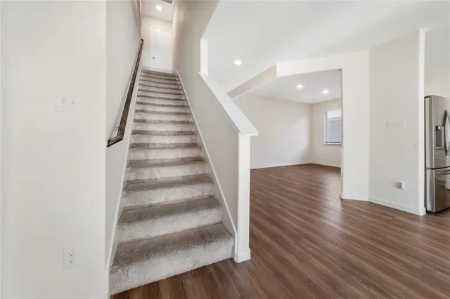 a view of entryway and hall with wooden floor