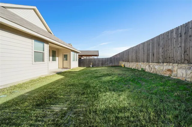 a view of an house with backyard space and garden