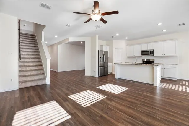 a view of kitchen with sink microwave and cabinets
