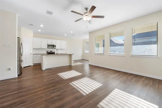 a view of kitchen with sink and wooden floor