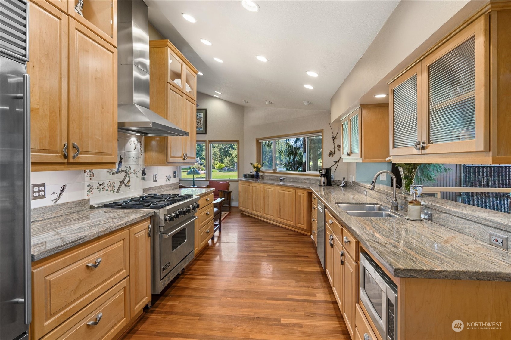 19804 Southeast 150th Street Renton, WA 98059 - Photo 14 of 40 a kitchen with stainless steel appliances granite countertop wooden cabinets a sink dishwasher a stove and a refrigerator