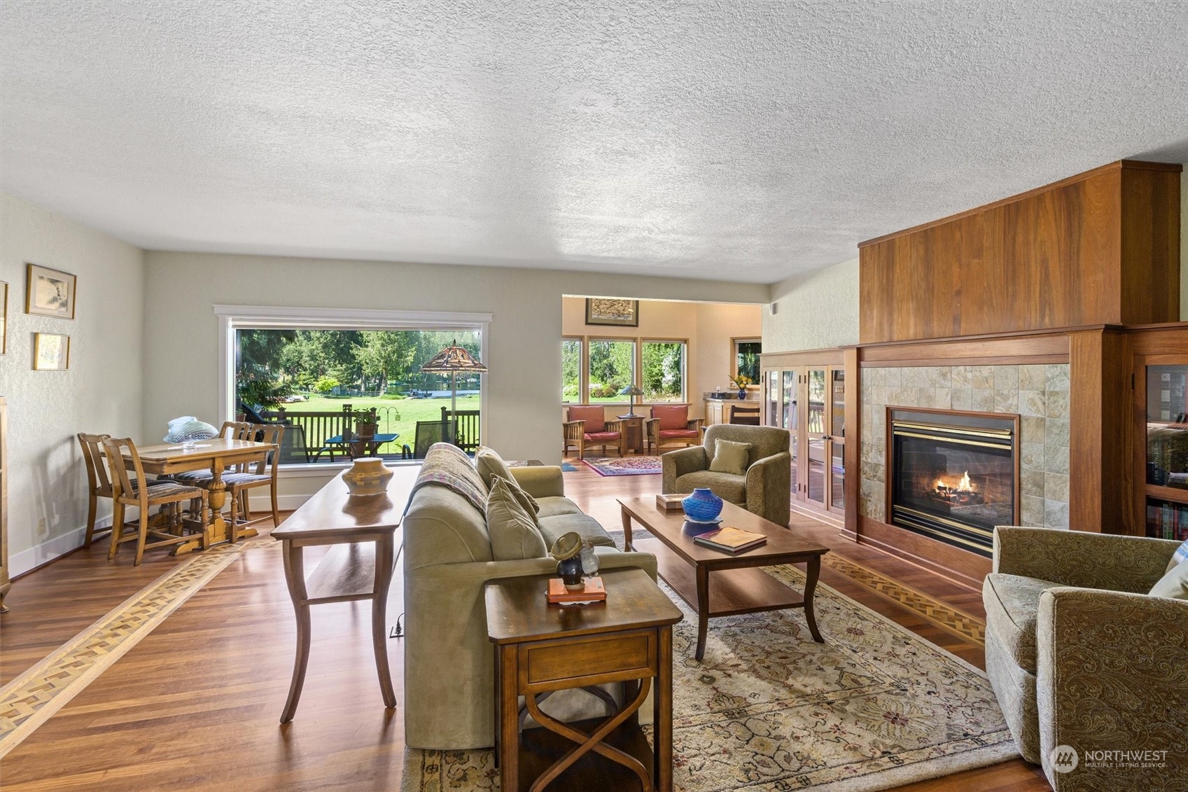 19804 Southeast 150th Street Renton, WA 98059 - Photo 19 of 40 a living room with furniture a fireplace a large window and a table