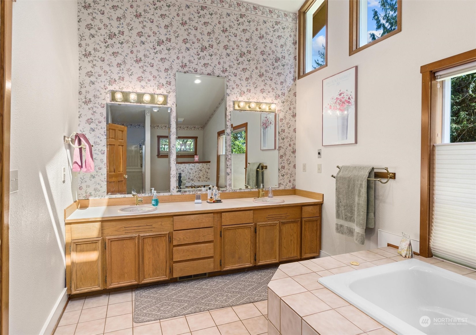 19804 Southeast 150th Street Renton, WA 98059 - Photo 26 of 40 a spacious bathroom with a sink and mirror with bathtub