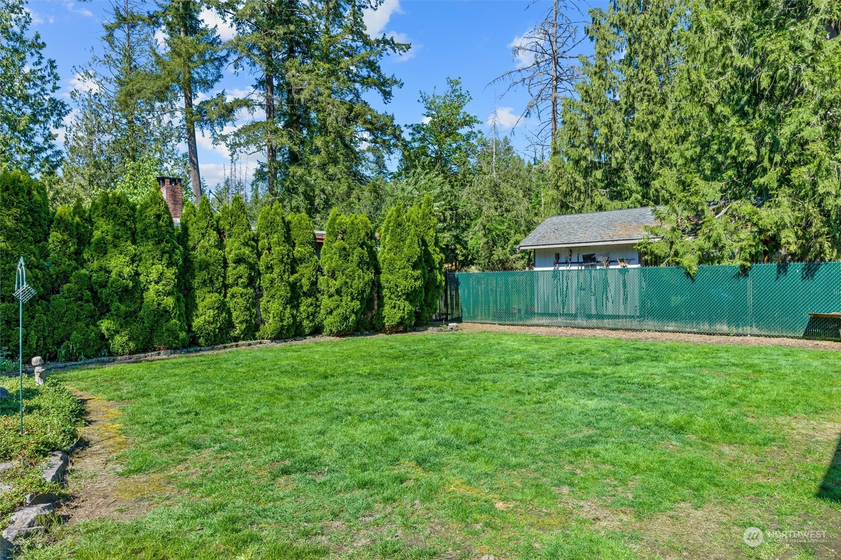 19804 Southeast 150th Street Renton, WA 98059 - Photo 35 of 40 a view of a backyard with large trees and wooden fence