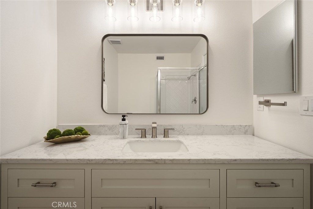 26941 Rainbow Glen Drive, Unit 751 Santa Clarita, CA 91351 - Photo 12 of 34 a bathroom with a sink vanity and a mirror