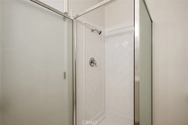 a bathroom with a glass shower door