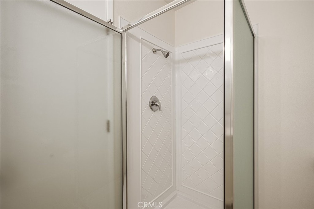 26941 Rainbow Glen Drive, Unit 751 Santa Clarita, CA 91351 - Photo 13 of 34 a bathroom with a glass shower door