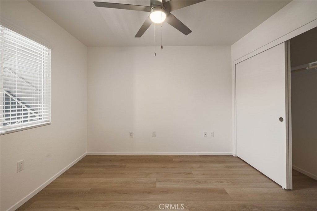 26941 Rainbow Glen Drive, Unit 751 Santa Clarita, CA 91351 - Photo 18 of 34 an empty room with a chandelier fan and windows