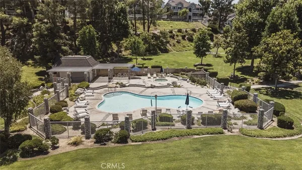 an aerial view of a house with a yard basket ball court and outdoor seating