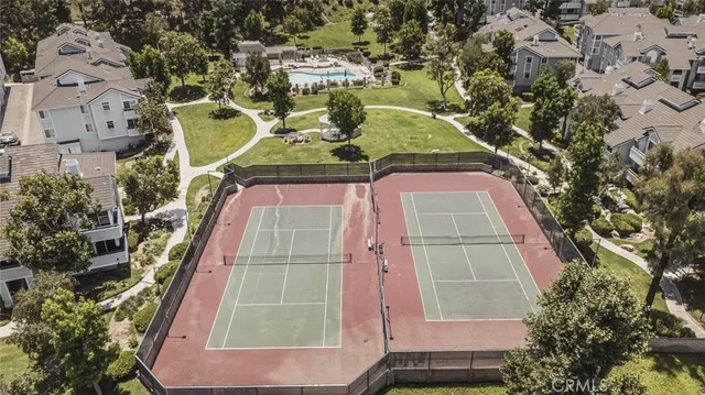 an aerial view of a residential houses with outdoor space