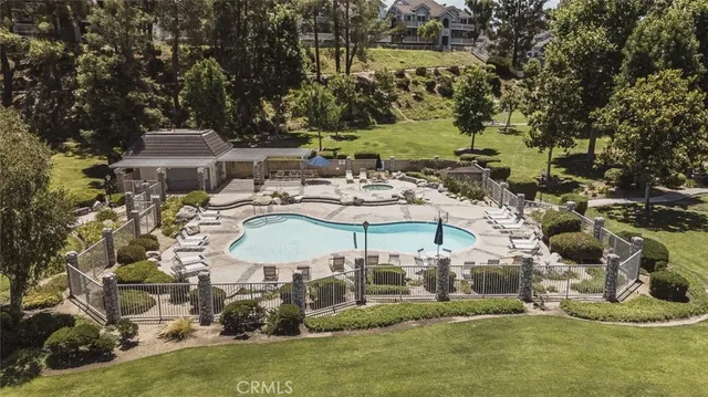 an aerial view of a house with a yard basket ball court and outdoor seating
