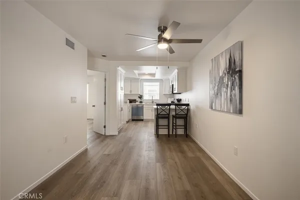 a view of a room with wooden floor and furniture