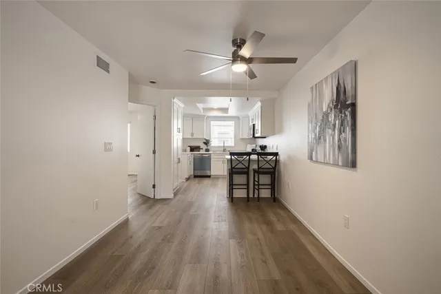 a view of a room with wooden floor and furniture