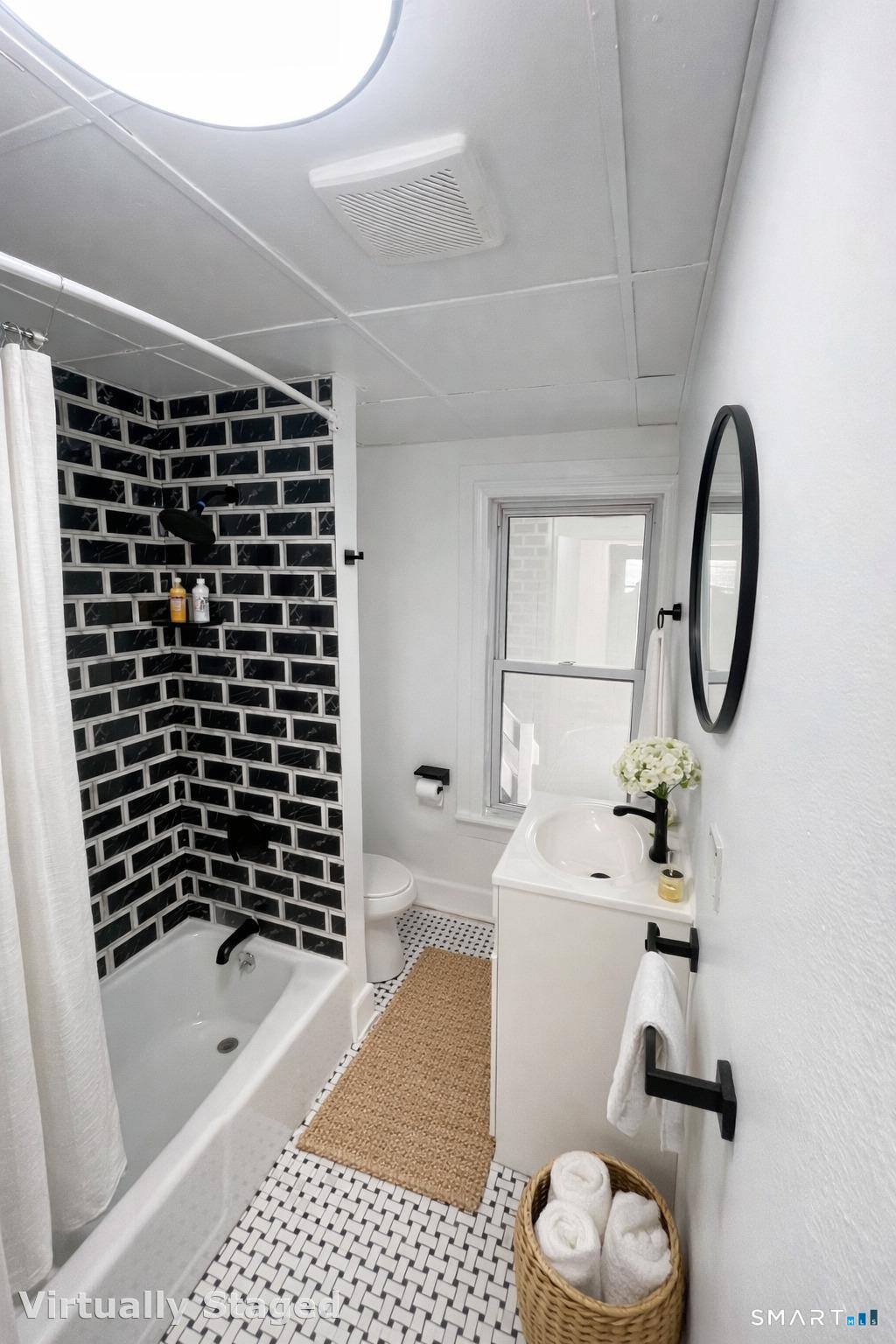 4 Division Street Danbury, CT 06810 - Photo 7 of 8 a bathroom with a sink a toilet and shower