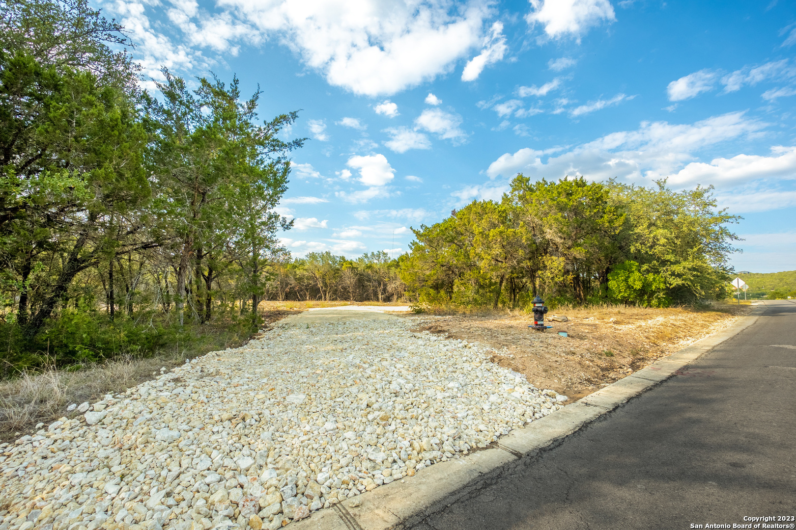 264 Pr 1709 Mico, TX 78056 - Photo 1 of 1 a view of a yard with wooden fence
