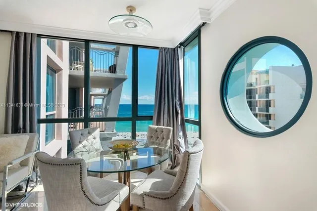 a dining room with furniture and a mirror