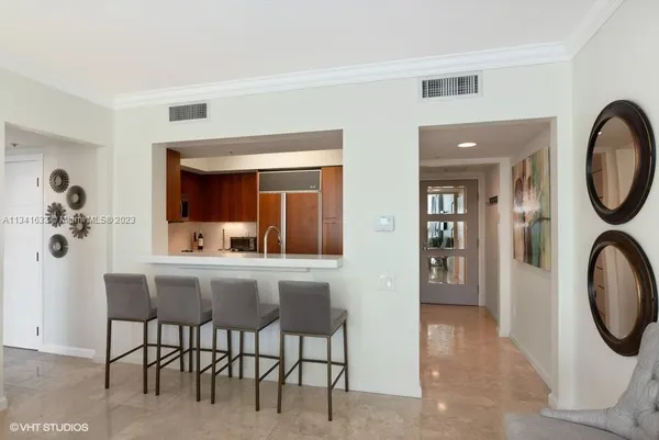 a dining room with furniture and a mirror
