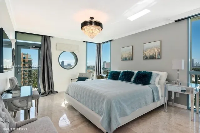 a bedroom with a bed and a chandelier