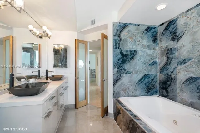 a bathroom with a tub sink and mirror