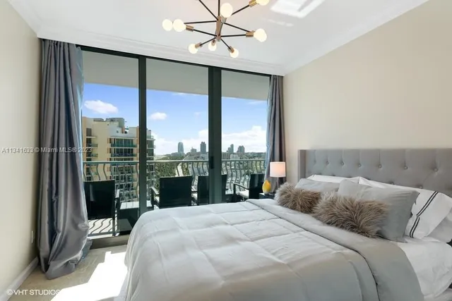 a bedroom with a large window and a bed