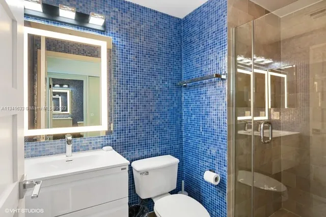 a bathroom with a toilet sink shower and mirror