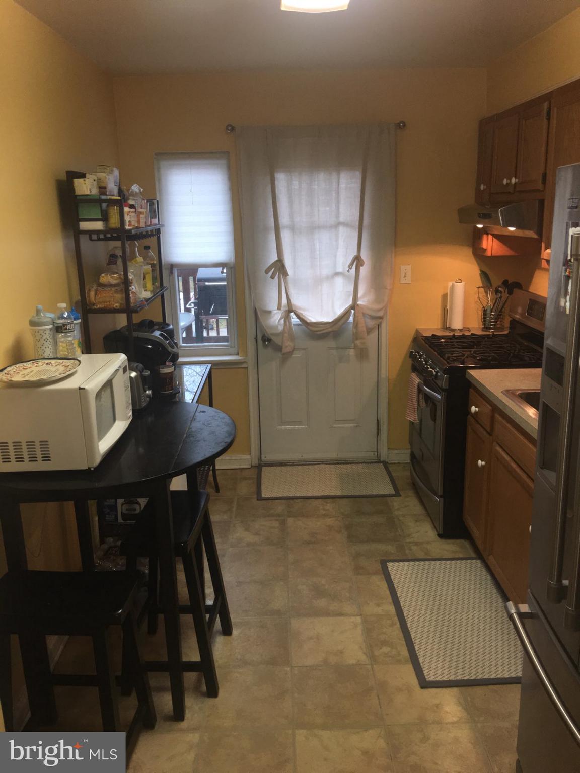 1728 Ingram Road Baltimore, MD 21239 - Photo 13 of 44 a kitchen with a table and chairs in it