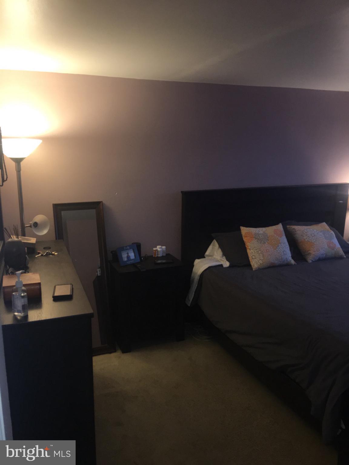 1728 Ingram Road Baltimore, MD 21239 - Photo 16 of 44 a bed sitting in a bedroom next to a lamp